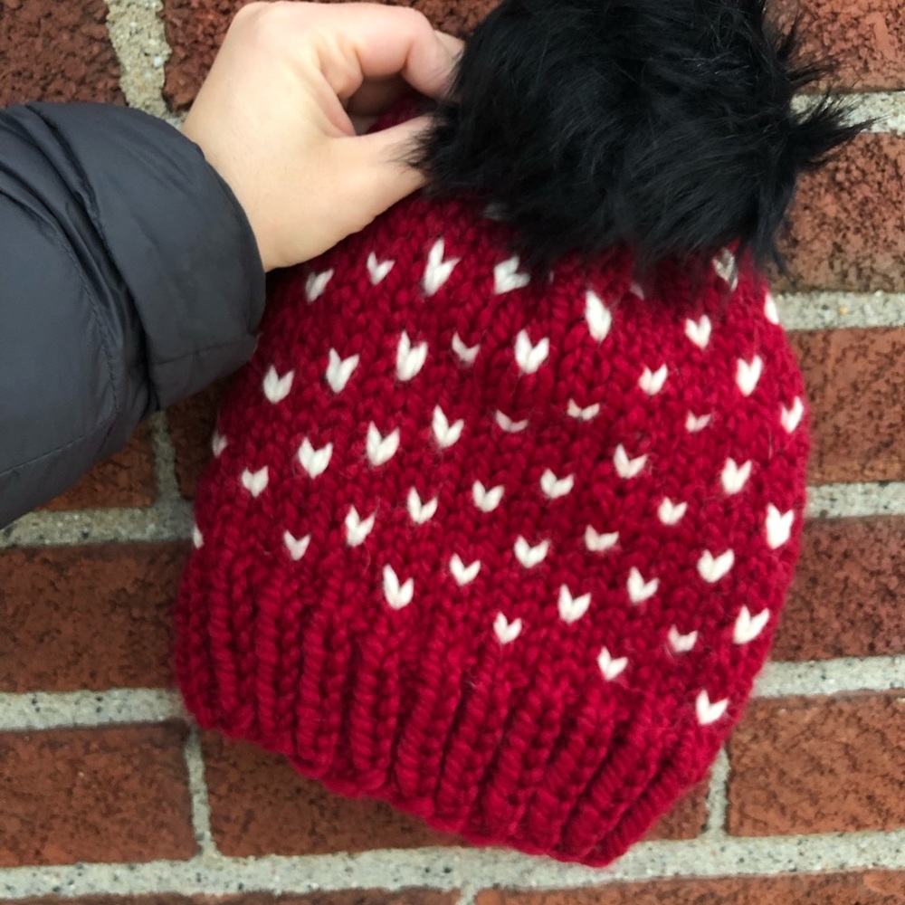 Hand knit hat with faux pompom